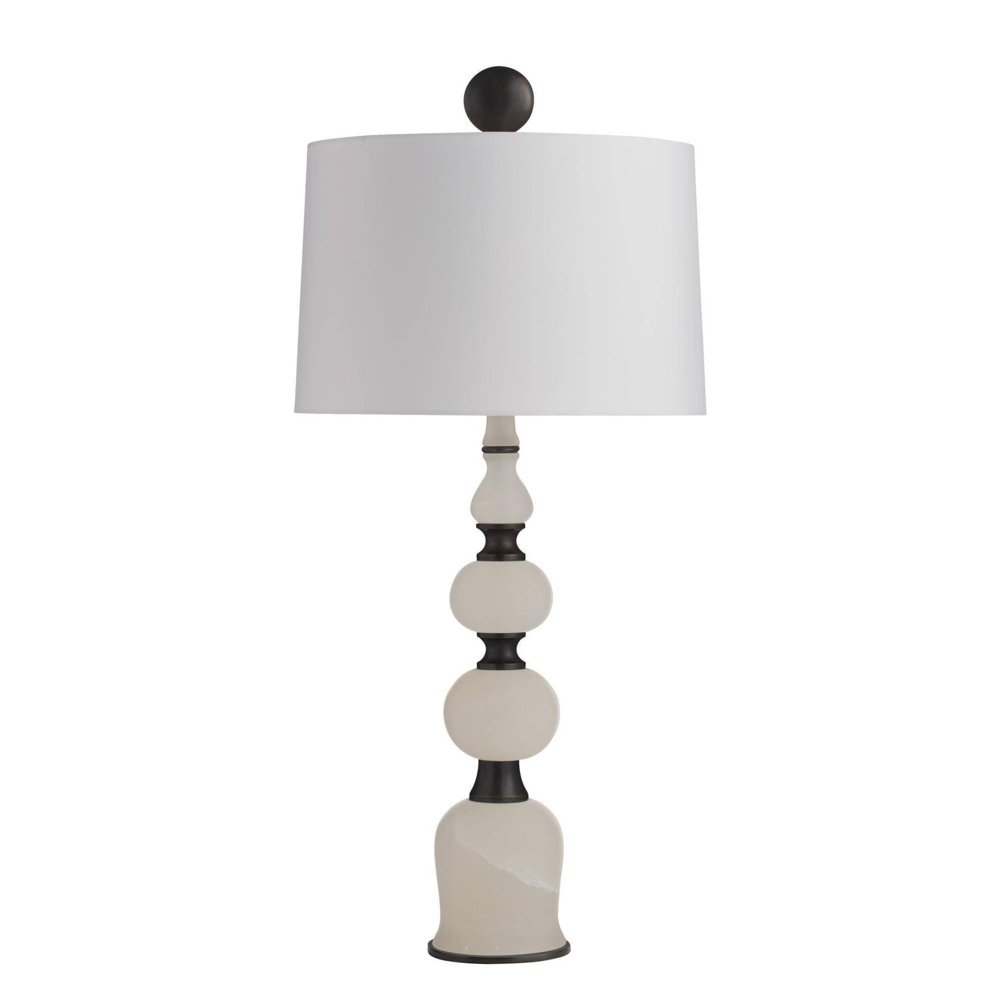 Decorative table lamp with a white shade and black and white base on a white background