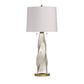Table lamp with a decorative base and white shade on a white background