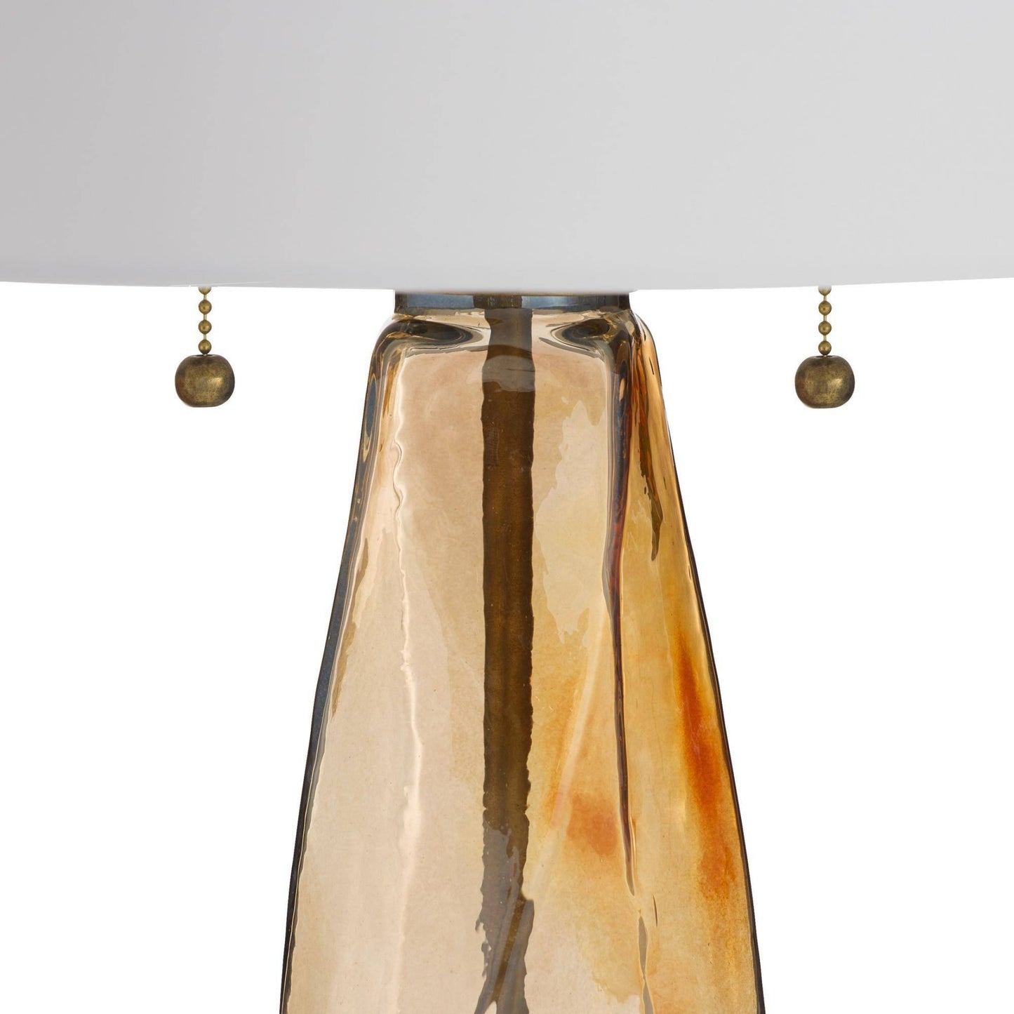 Close-up of a pendant light fixture with a brown glass shade and gold accents on a white background.