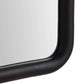 Close-up of a black-framed mirror on a white background