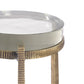 A modern accent table with a round white top and a textured, woven metallic gold base, shown against a plain white background.