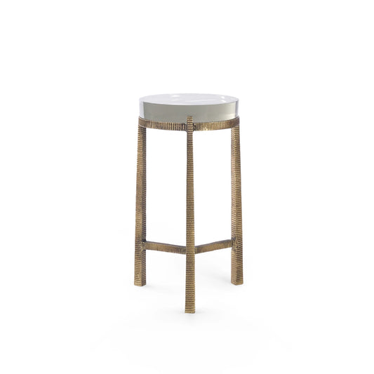 A modern accent table with a round white top and a textured, woven metallic gold base, shown against a plain white background.