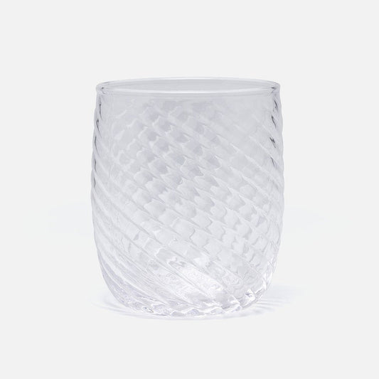 A clear textured glass tumbler with a diamond-patterned surface and diagonal ribbed sides, shown on a light gray background.