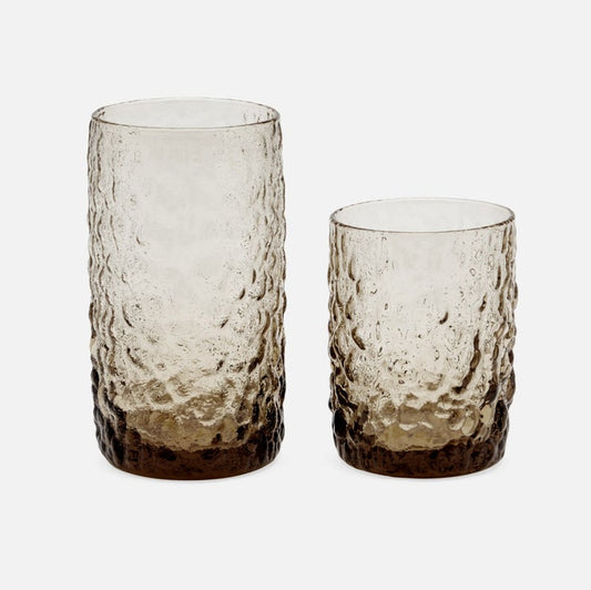 Two textured glass tumblers on a white background