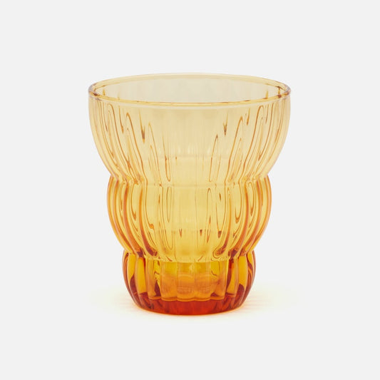 A translucent amber-colored glass tumbler with a ribbed, textured design, shown on a clean white background.