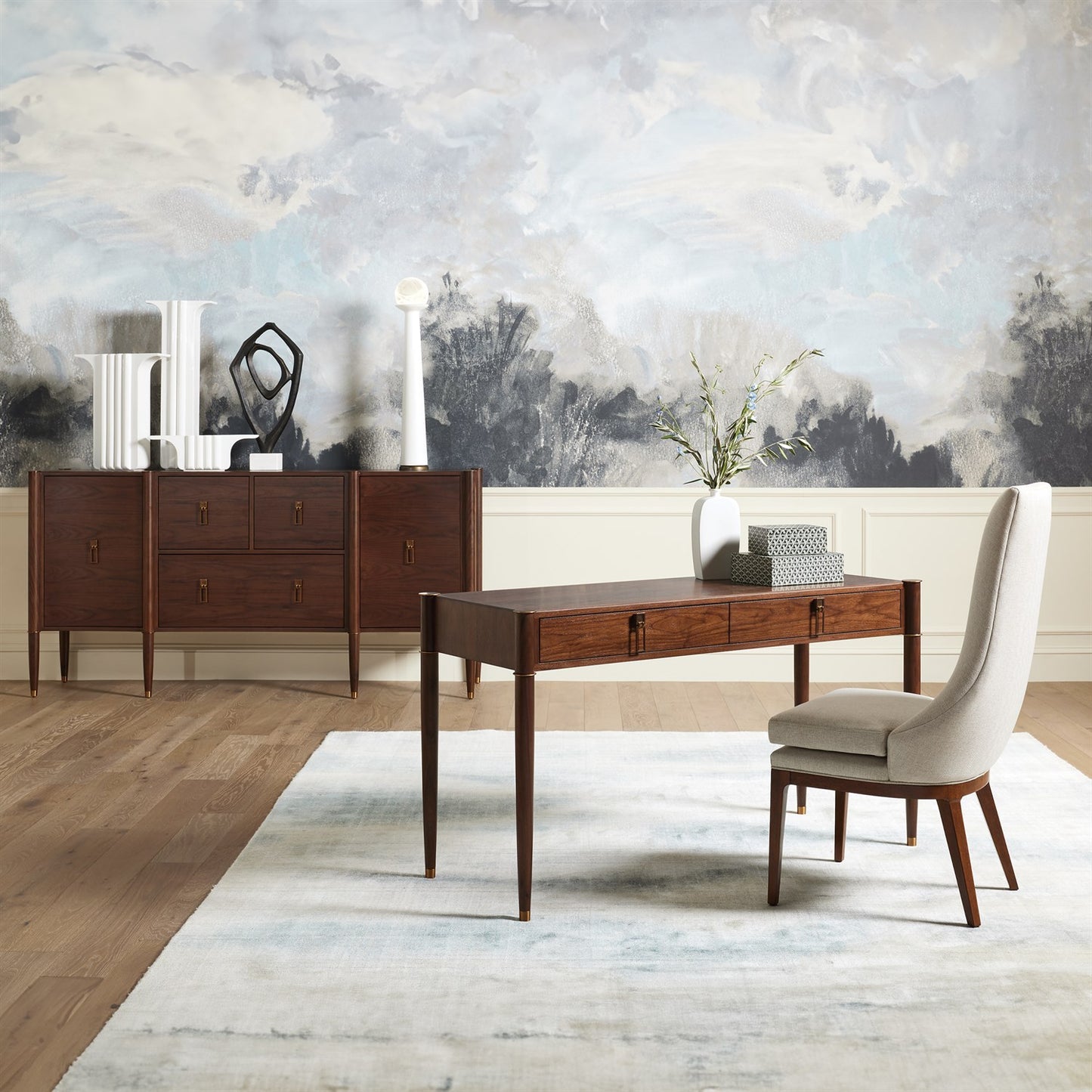 Wooden desk with chair in a room with abstract wall art