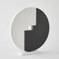 Abstract sculpture with circular design on a white background