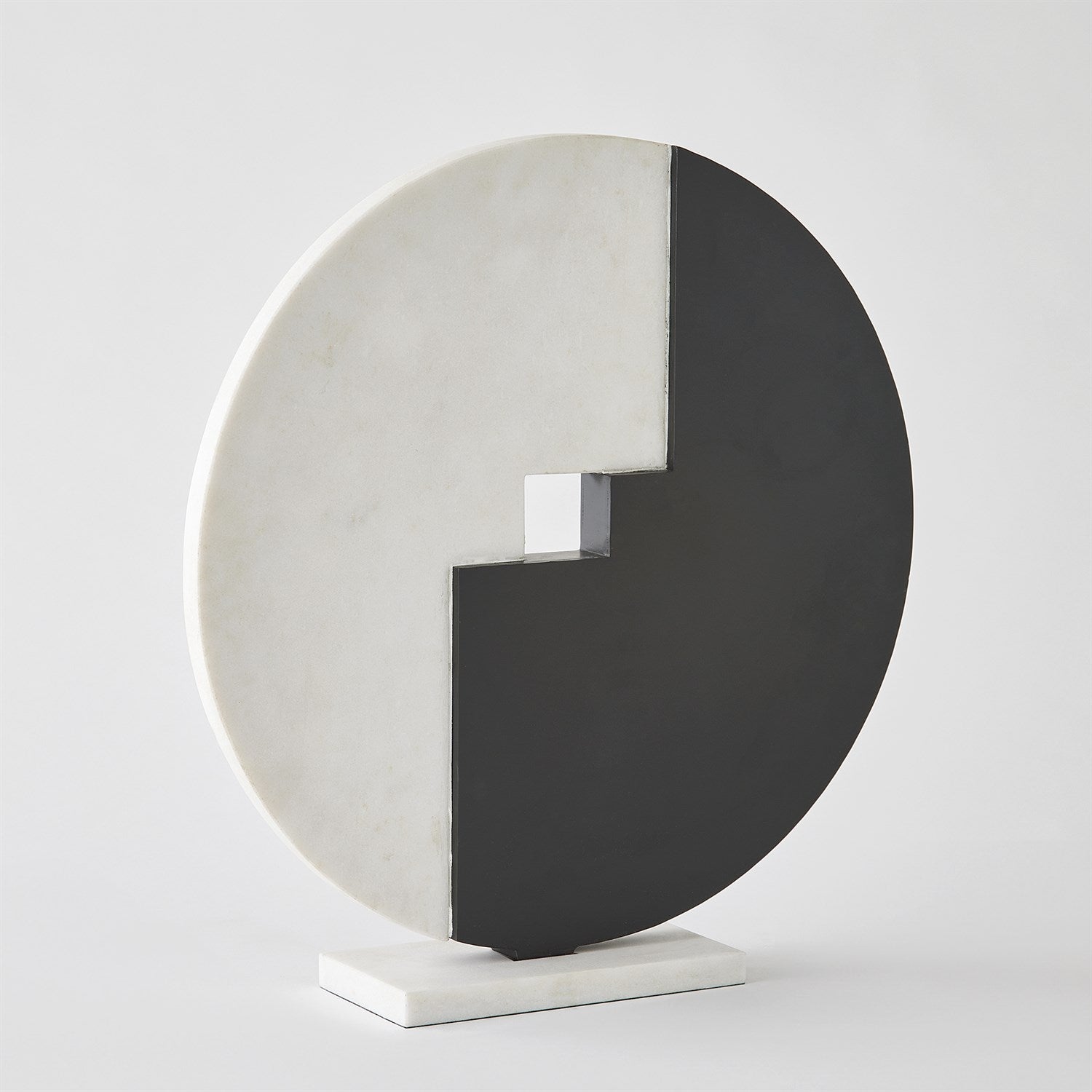 Abstract sculpture with circular design on a white background