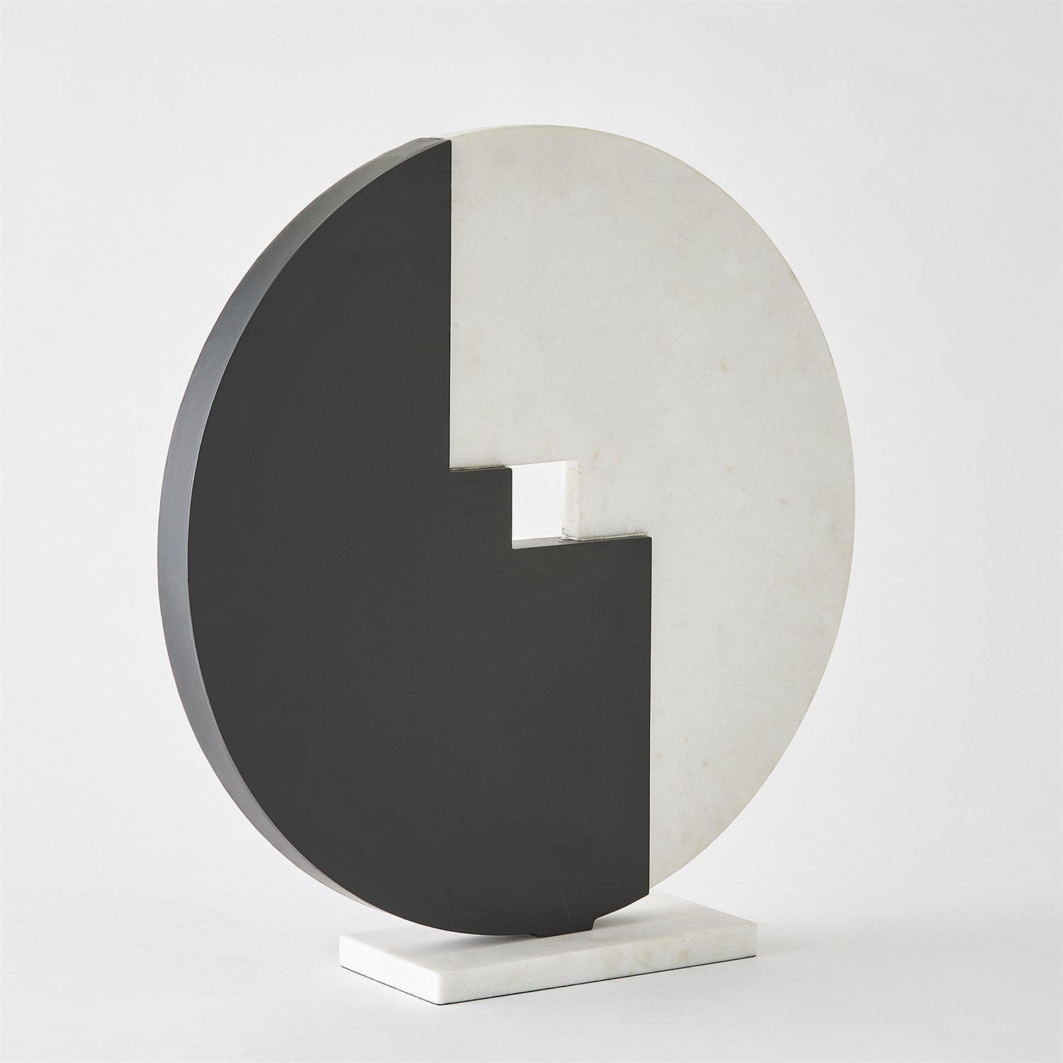 Modern decorative piece with a black and white circular design on a light gray background