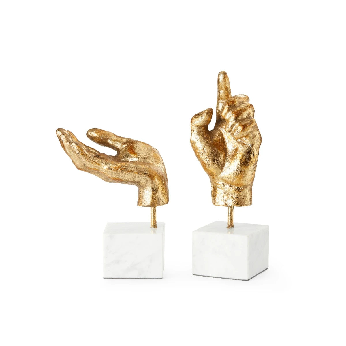 Two gold hand sculptures on white pedestals against a white background