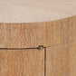 Close-up detail of a light oak wood cabinet showing the grain texture, a small brass pull handle, and the seam between the front doors.