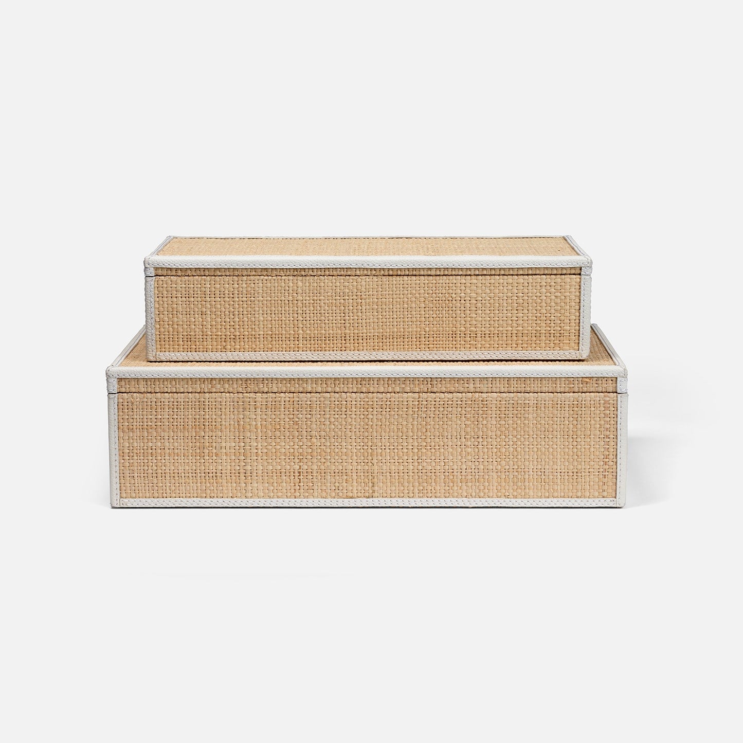 Set of two woven storage boxes with white frames on a light gray background