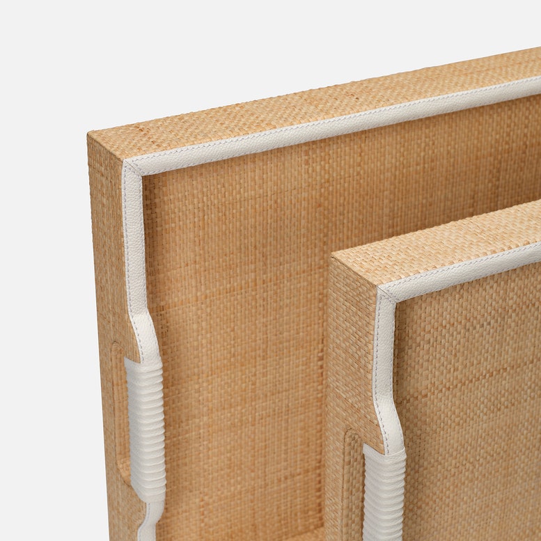 Close-up of a woven wooden frame with white trim on a light gray background