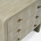 Close-up of a textured dresser with gold handles on a white background
