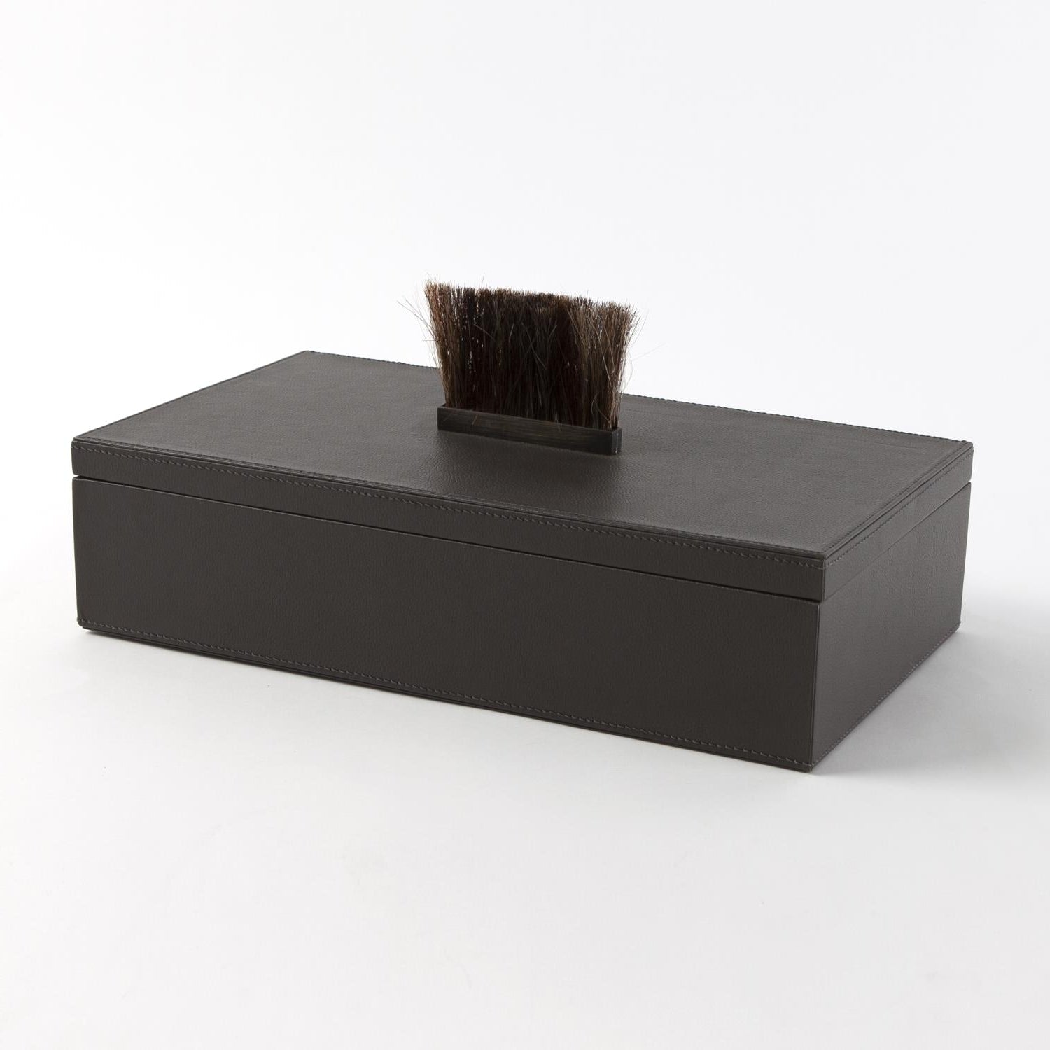 Black leather box with a brush on a white background