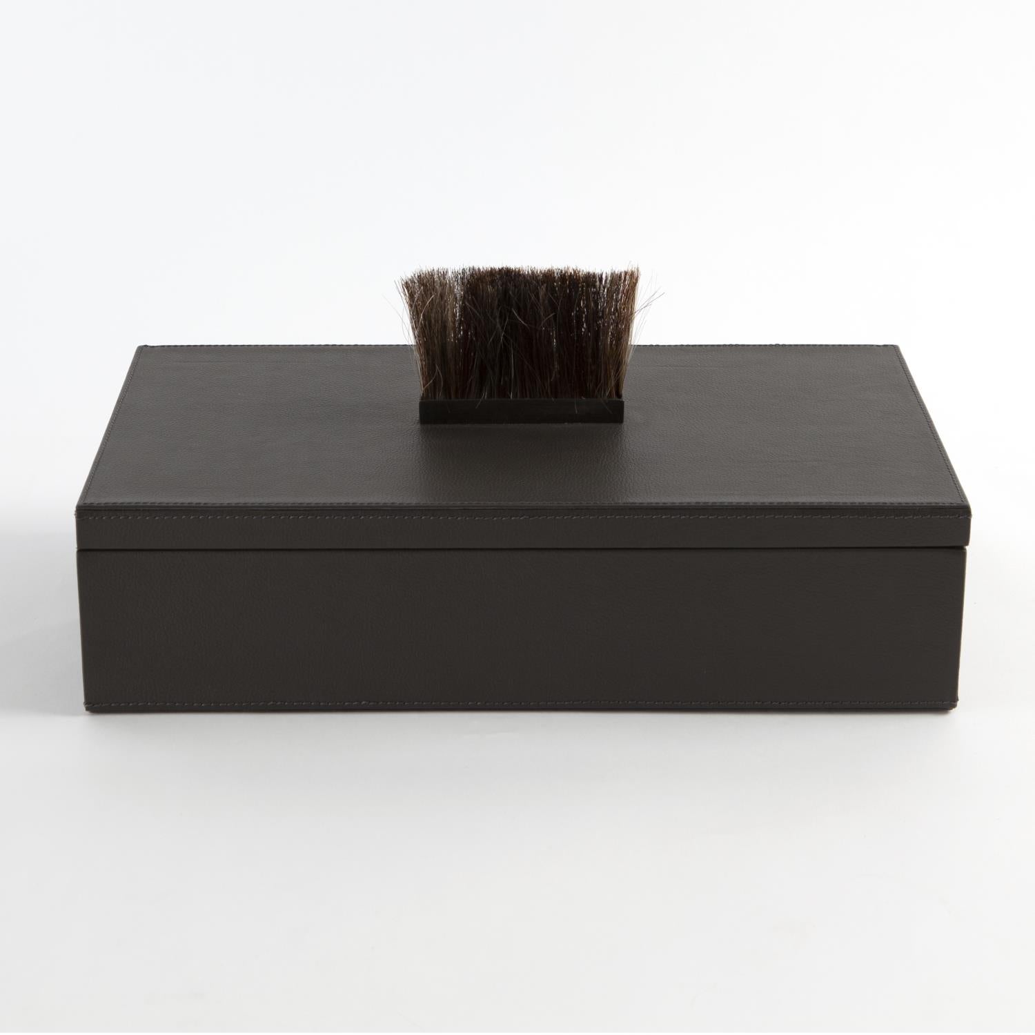 Black rectangular box with a brush on a white background