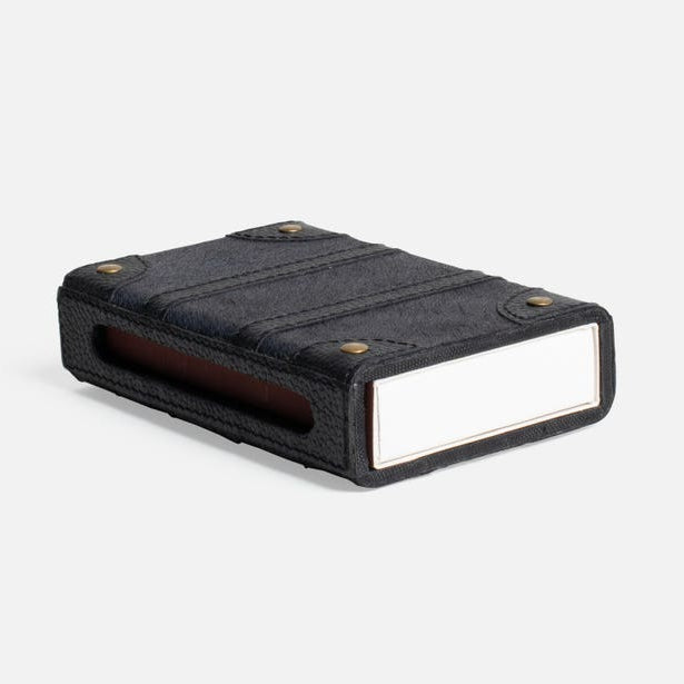 Black rectangular object with a reflective surface on a white background