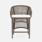 Wicker chair with a white cushion on a light gray background