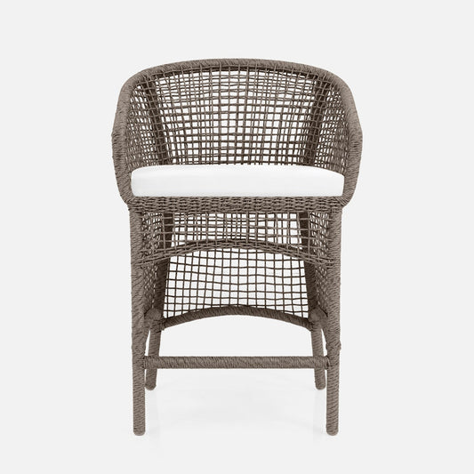 Wicker chair with a white cushion on a light gray background