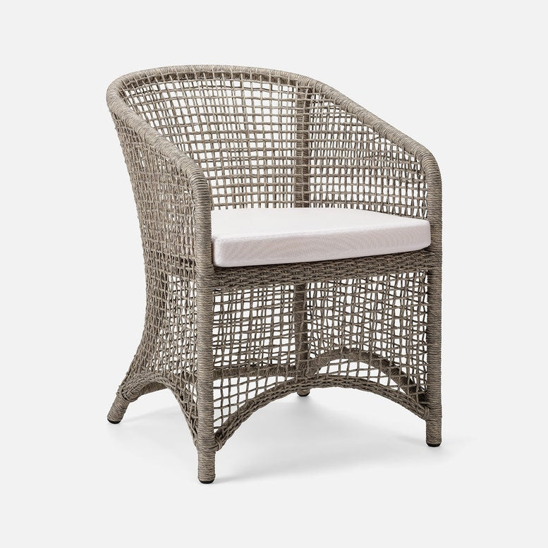Wicker chair with a cushion on a white background