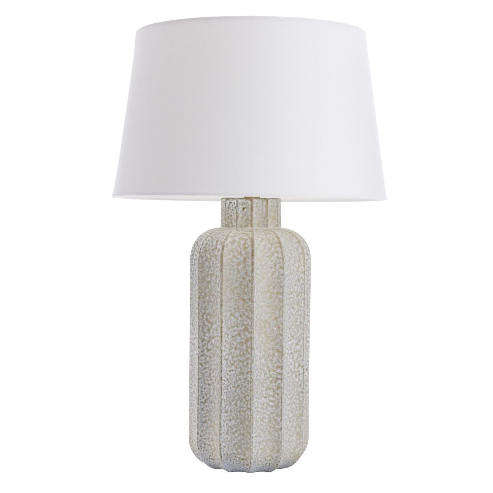 Table lamp with textured base and white shade on a white background