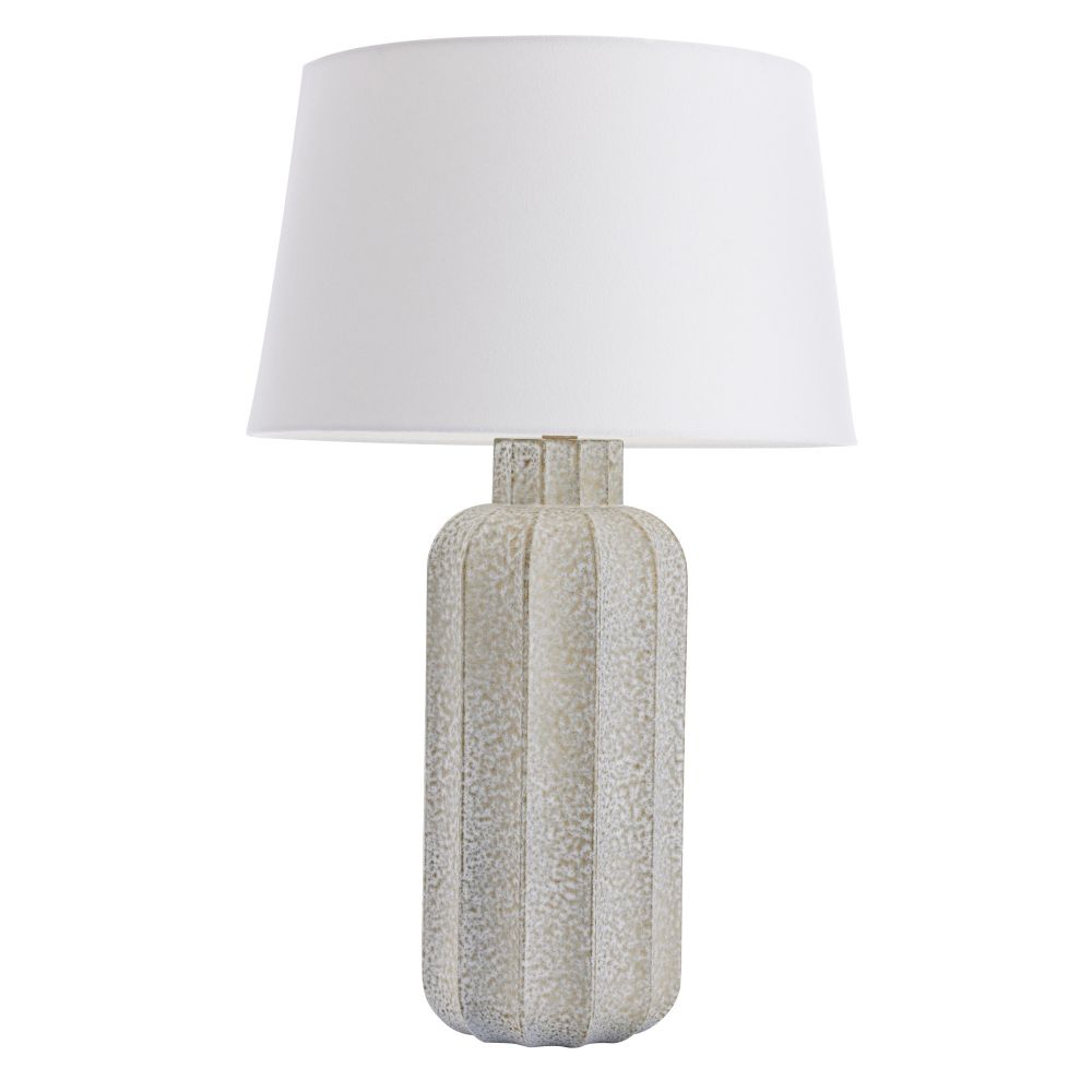 Table lamp with textured base and white shade on a white background