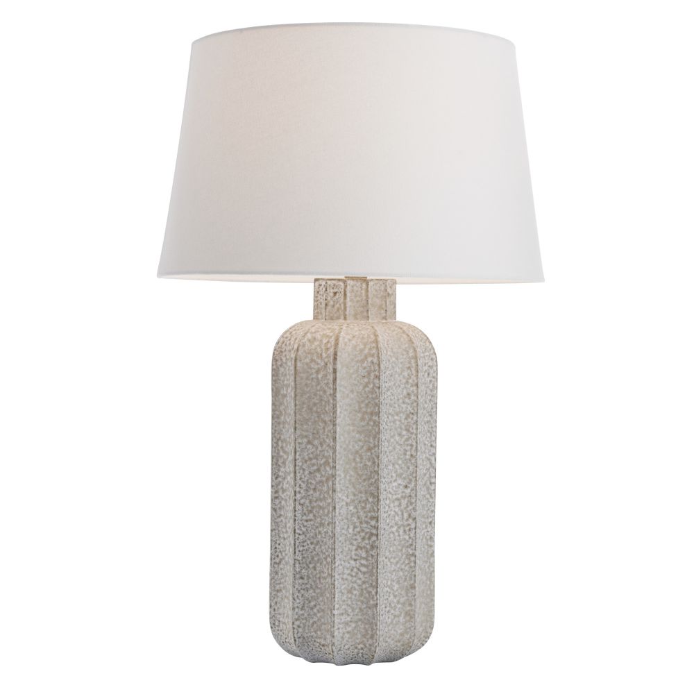 Table lamp with textured ceramic base and white shade on a white background
