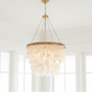 Chandelier hanging in a room with large windows
