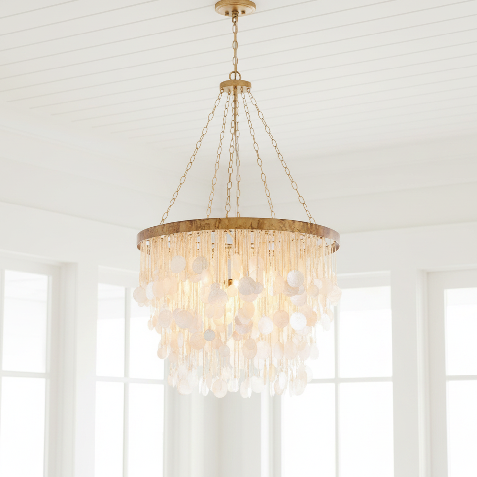 Chandelier hanging in a room with large windows