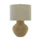 Table lamp with a textured beige base and a matching shade on a white background
