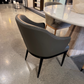 Gray chair in a modern indoor setting with a polished concrete floor.