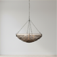 Decorative hanging light fixture with wavy glass shade on a plain background