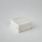 White rectangular box with gold accents on a white background