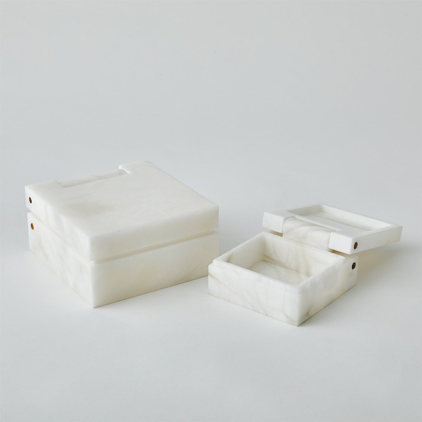 Two white marble boxes on a light gray background