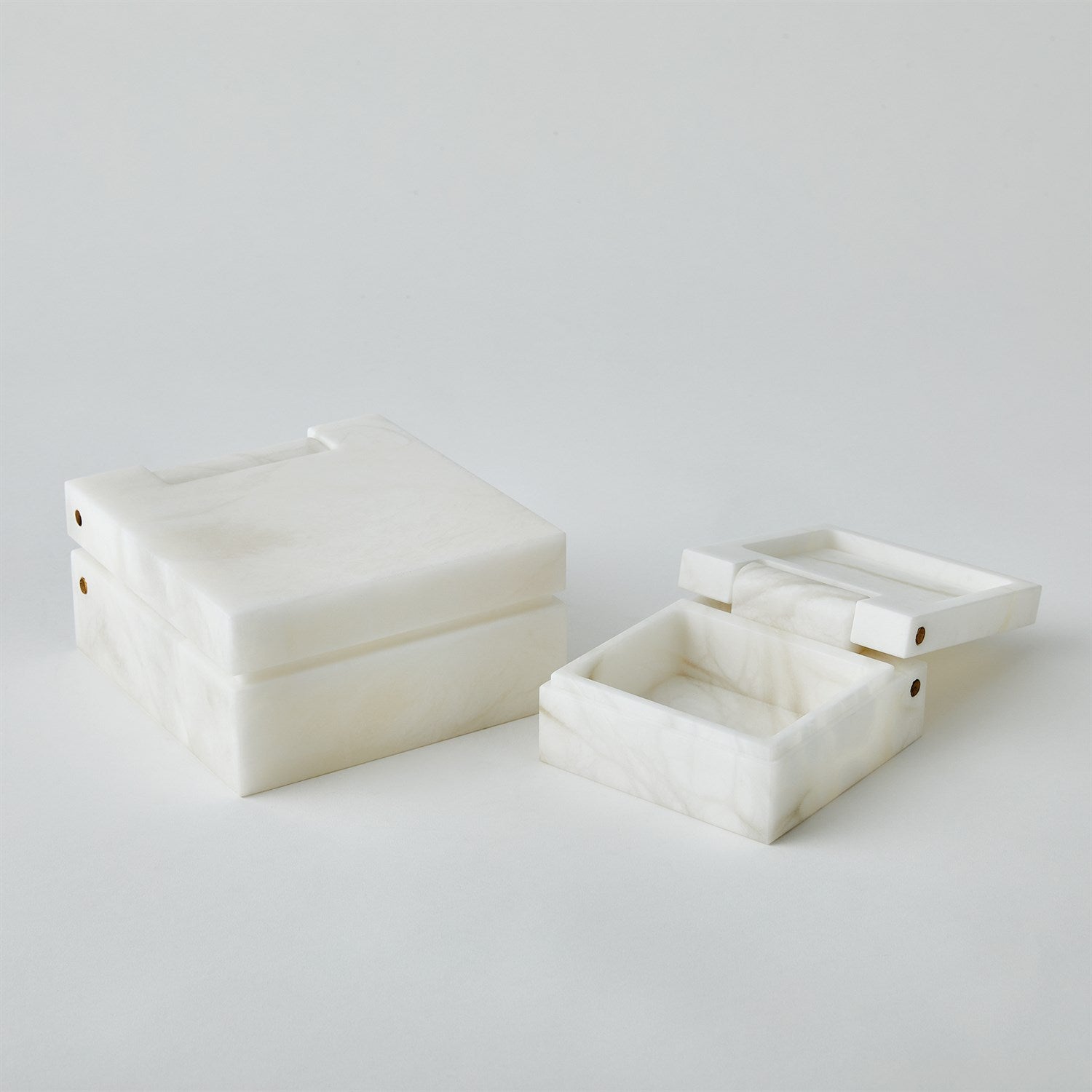 Two white marble boxes on a light gray background