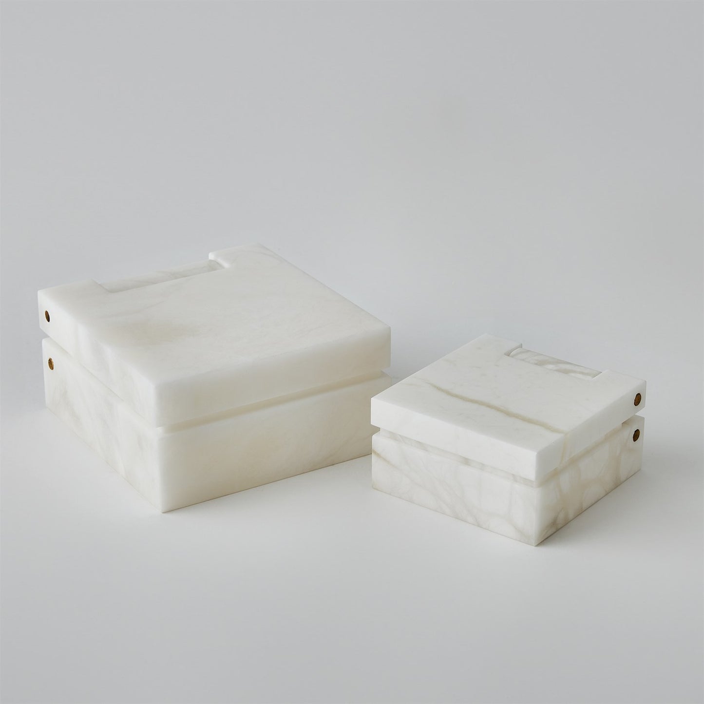 Two white marble boxes on a light gray background