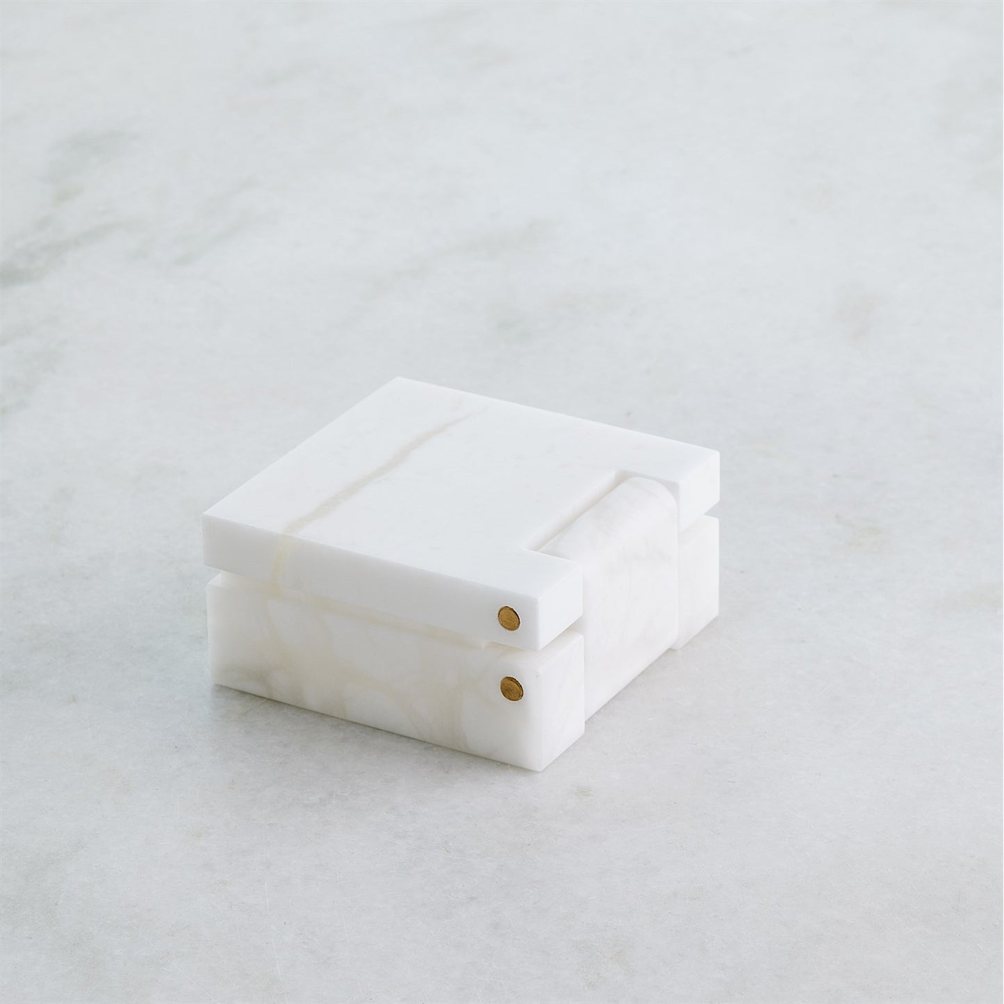 White jewelry box on a light gray surface