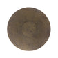 Round stone coaster with a textured surface on a white background
