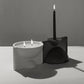 Modern candle holder with two candles on a neutral background