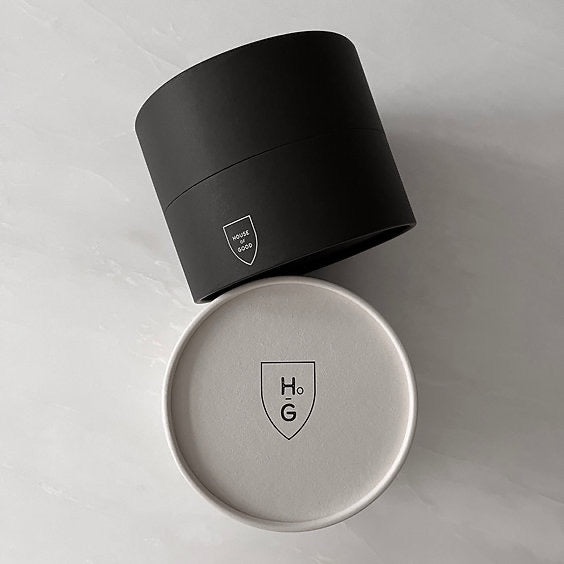 Black and silver cylindrical containers with a logo on a light gray background