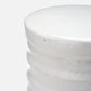 Close-up of a white marble cylindrical object on a light gray background