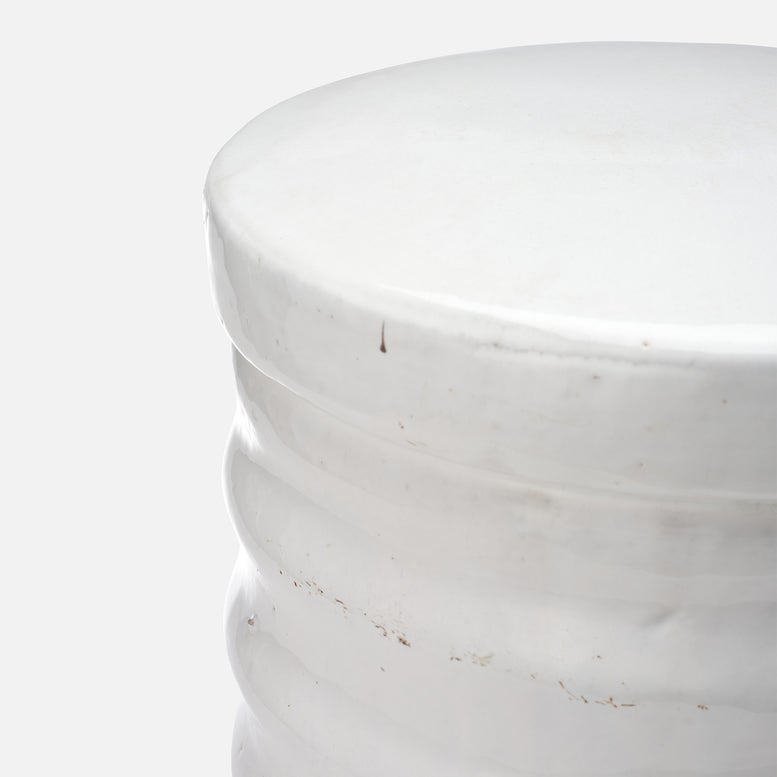 Close-up of a white marble cylindrical object on a light gray background