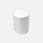 White cylindrical container with cotton pads on a white background