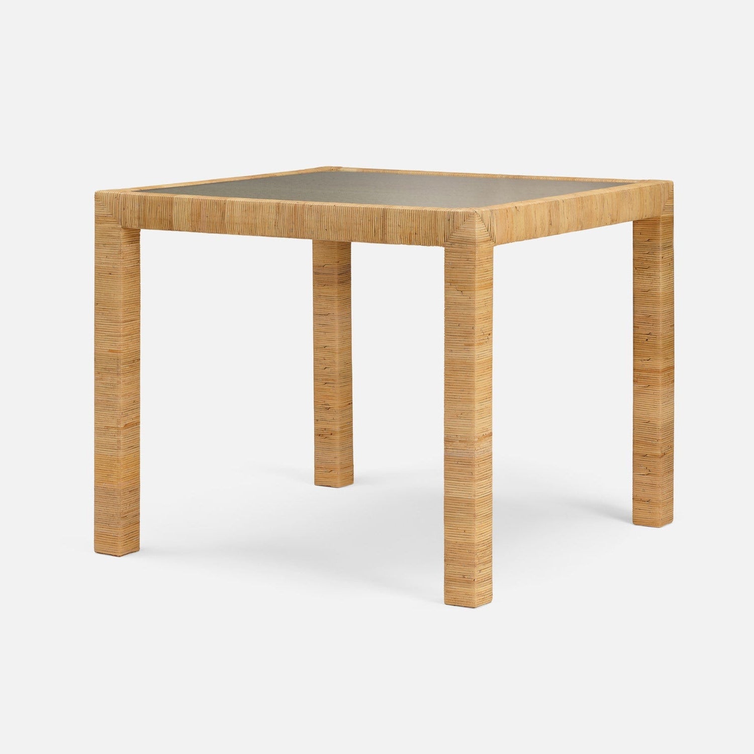 Square table with wicker legs and a concrete top on a white background