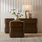 Wooden dresser with decorative items against a neutral wall