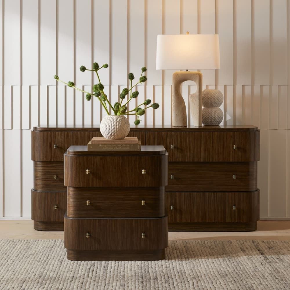 Wooden dresser with decorative items against a neutral wall