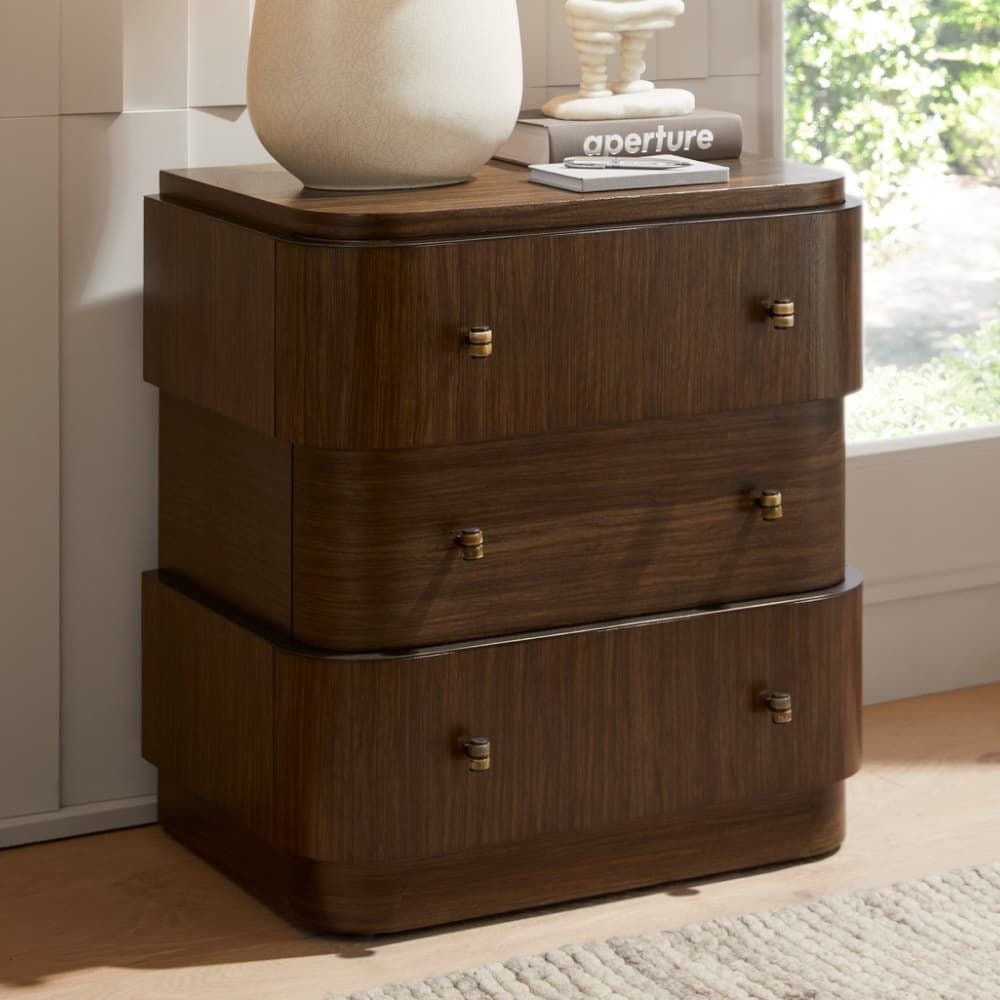 Wooden dresser with three drawers in a room with a window and rug.