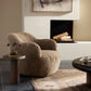 Textured armchair in a living room with a fireplace and coffee table.