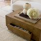 Wooden coffee table with decorative items in a living room setting
