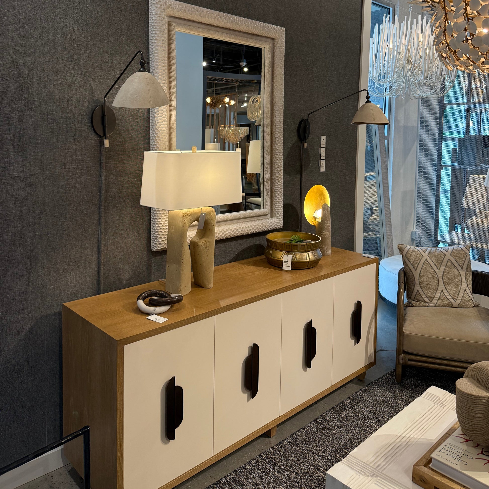 Modern living room with a coffee table, chairs, and decorative items.